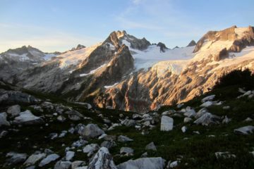 Morning sun casts a warm light on Gunsight Peak & Dome Peak viewed from White Rock Lakes during the Ptarmigan Traverse in the North Cascades, WA.