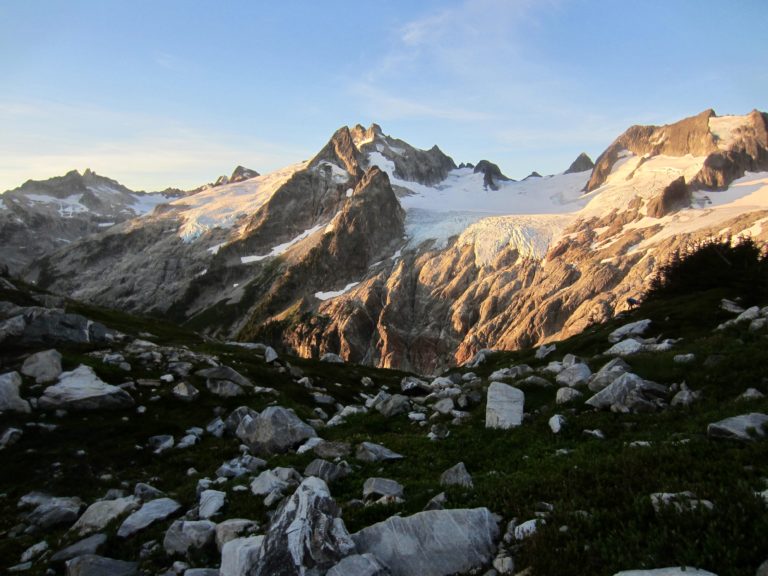 Morning sun casts a warm light on Gunsight Peak & Dome Peak viewed from White Rock Lakes during the Ptarmigan Traverse in the North Cascades, WA.