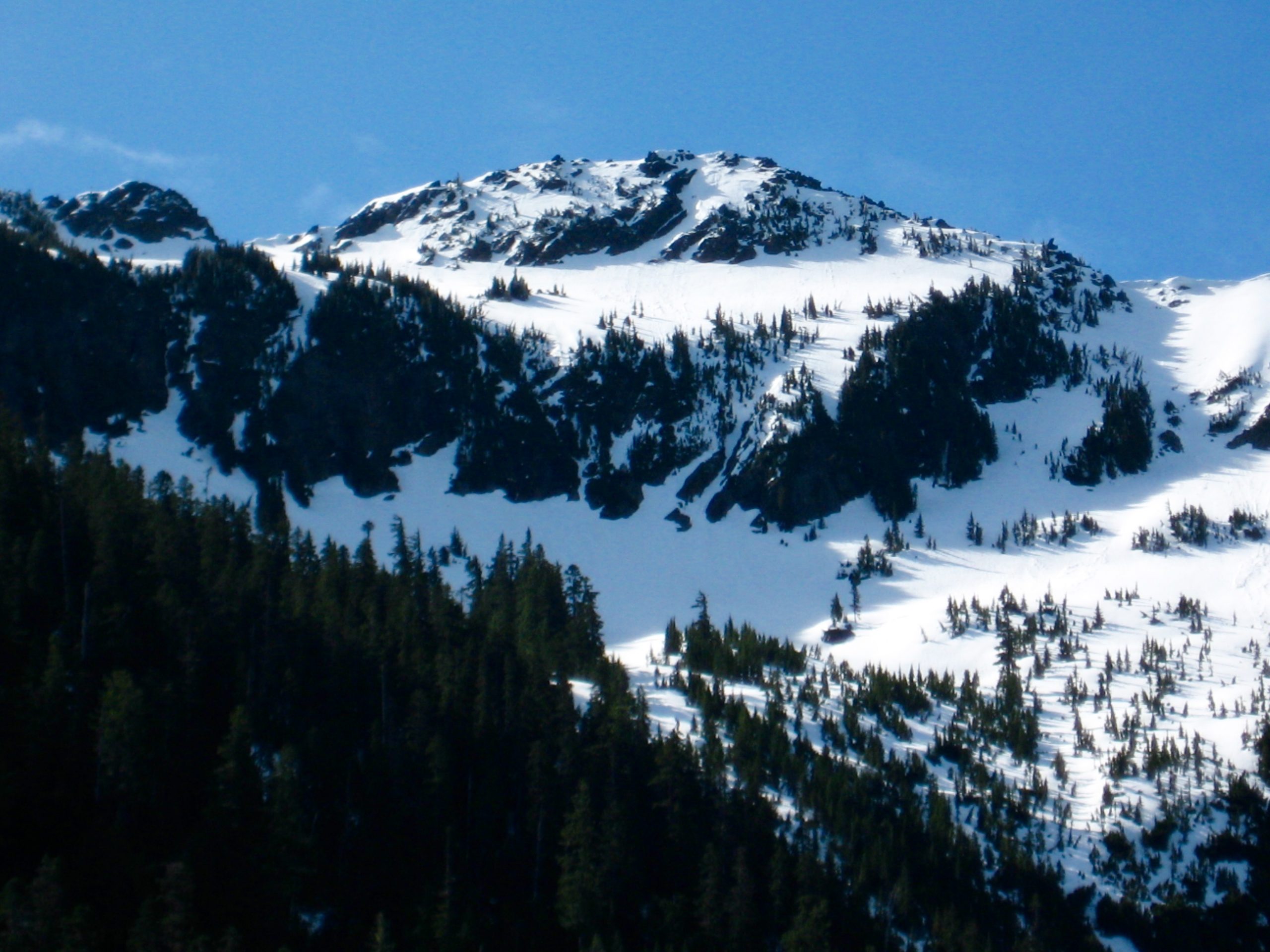 Looking up at the snow-plastered northwest face of Jim Hill Mountain from Lanham Lake in the Cascades