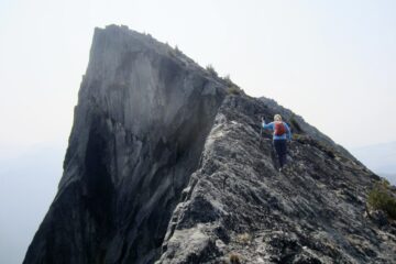 A climber scrambles up the narrow north ridge of Mt. Lindeman in the Canadian Chilliwack Mountains