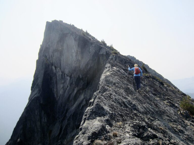 A climber scrambles up the narrow north ridge of Mt. Lindeman in the Canadian Chilliwack Mountains