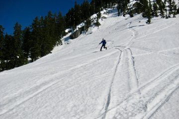 A backcountry skier makes telemark turns during the Nason-Smith Ski Traverse near Stevens Pass