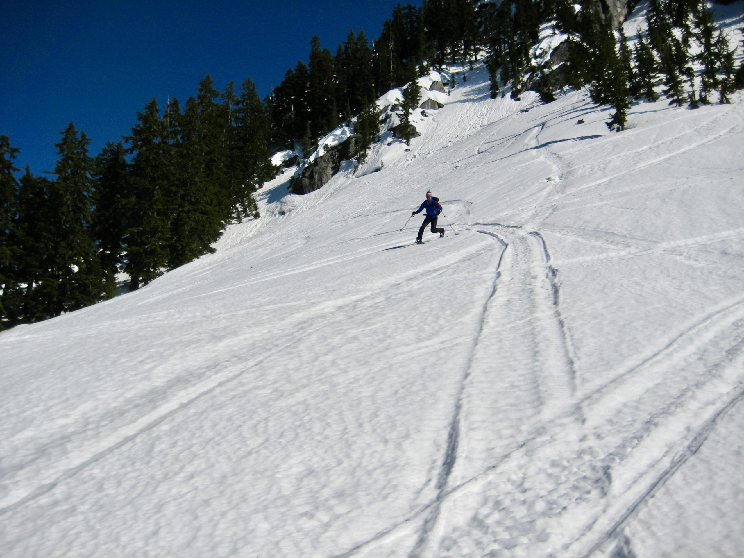 A backcountry skier makes telemark turns during the Nason-Smith Ski Traverse near Stevens Pass