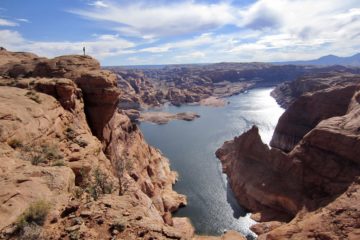The blue waters of Lake Powell can be seen through a narrow canyon called Hole-in-the-Rock located in southern Utah