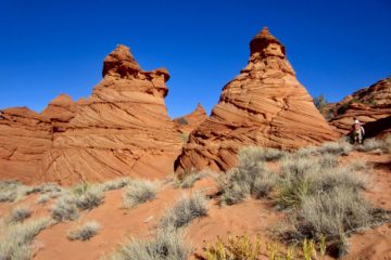 Two red sandstone teepees in Coyote Buttes South display distinctive layering and cross-bedding