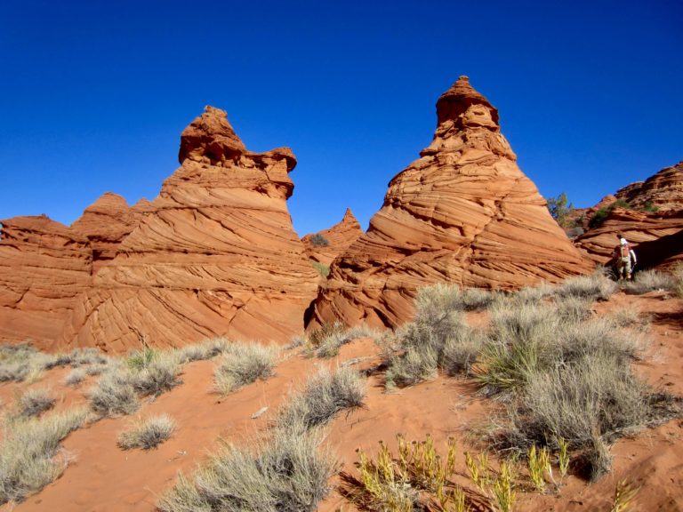 Two red sandstone teepees in Coyote Buttes South display distinctive layering and cross-bedding