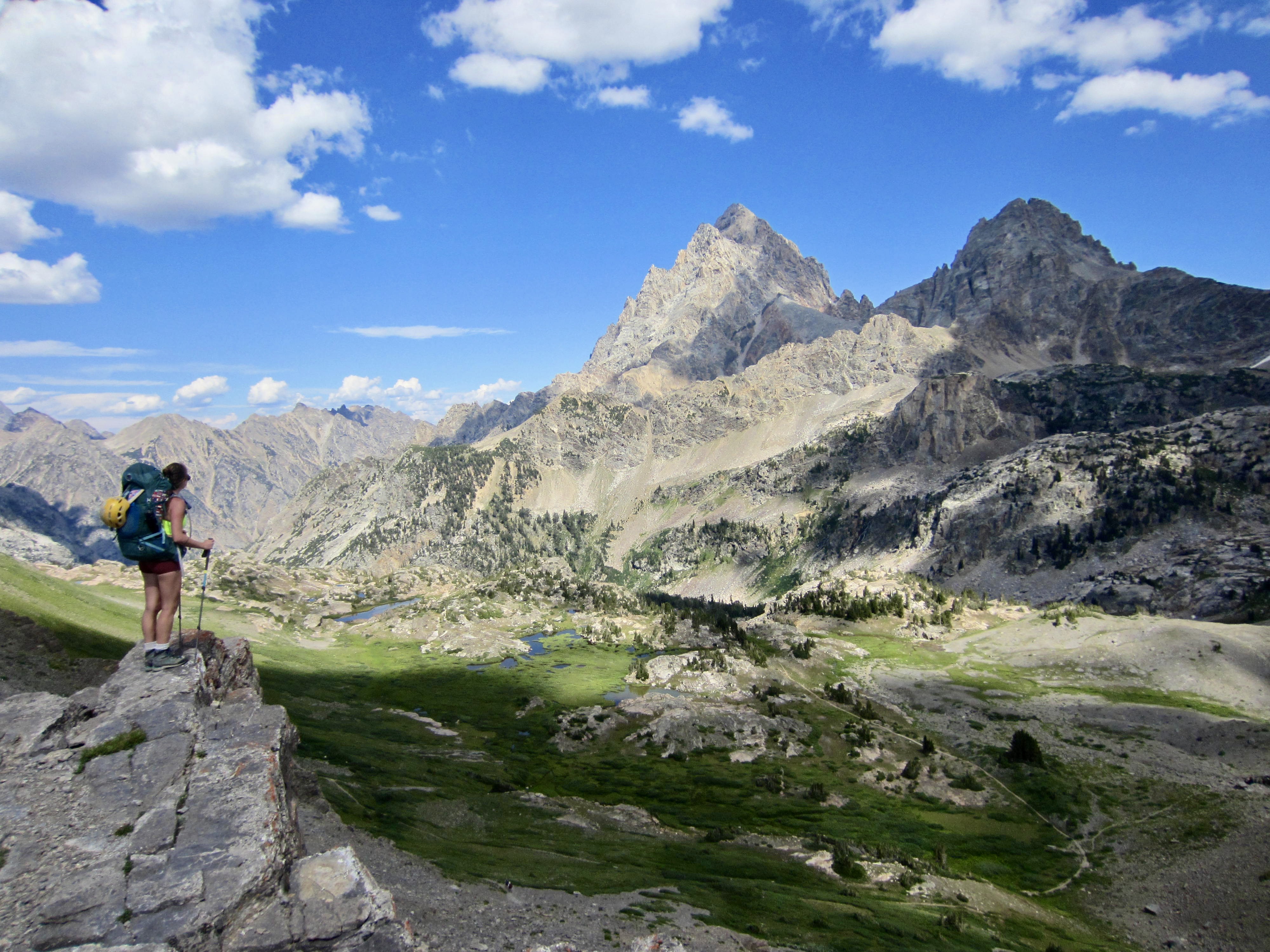 A hiker gazes at Grand Teton from Hurricane Pass during the Teton Crest Trail Traverse in Wyoming