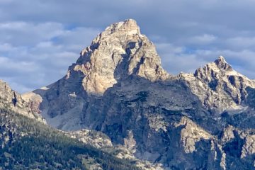 Sunrise hits the eastern face of Grand Teton as seen from Jackson Hole, Wyoming